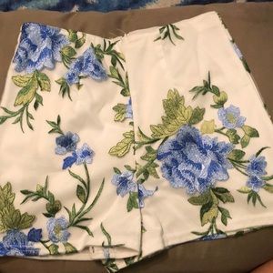 White shorts with blue flowers embroidered